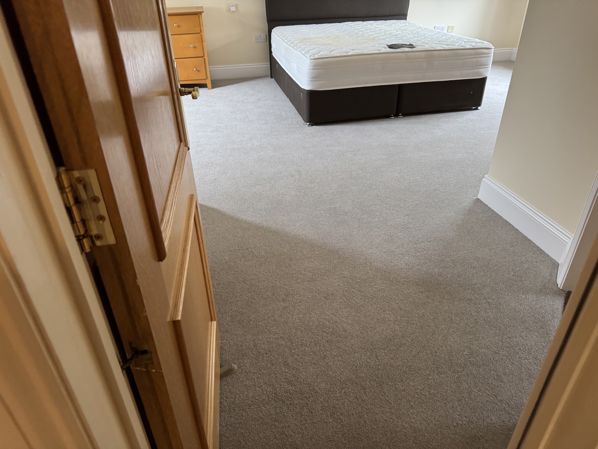 Freshly fitted light carpet in a bedroom